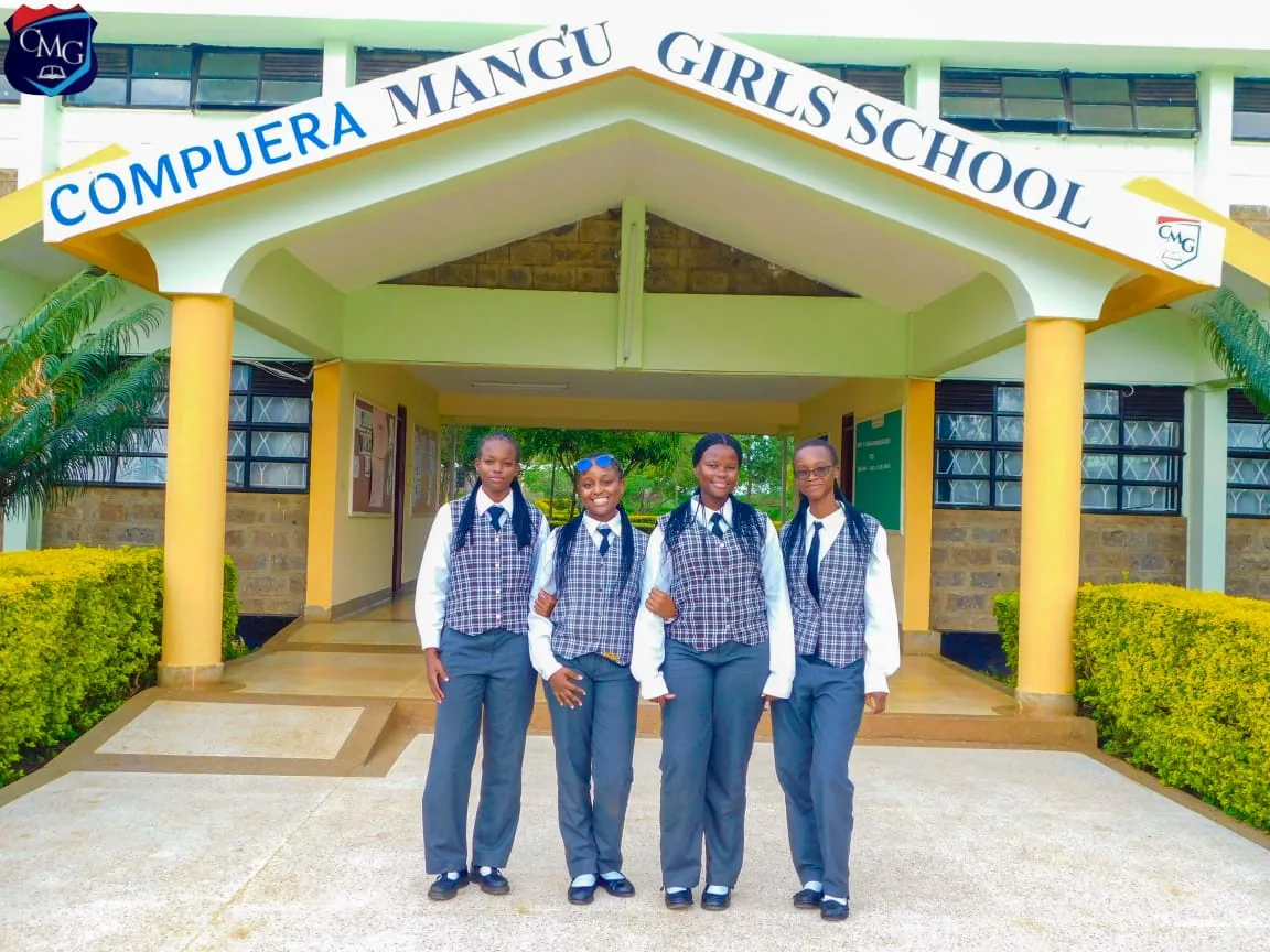 Compuera Mang'u Girls School students at the school entrance archway in Thika